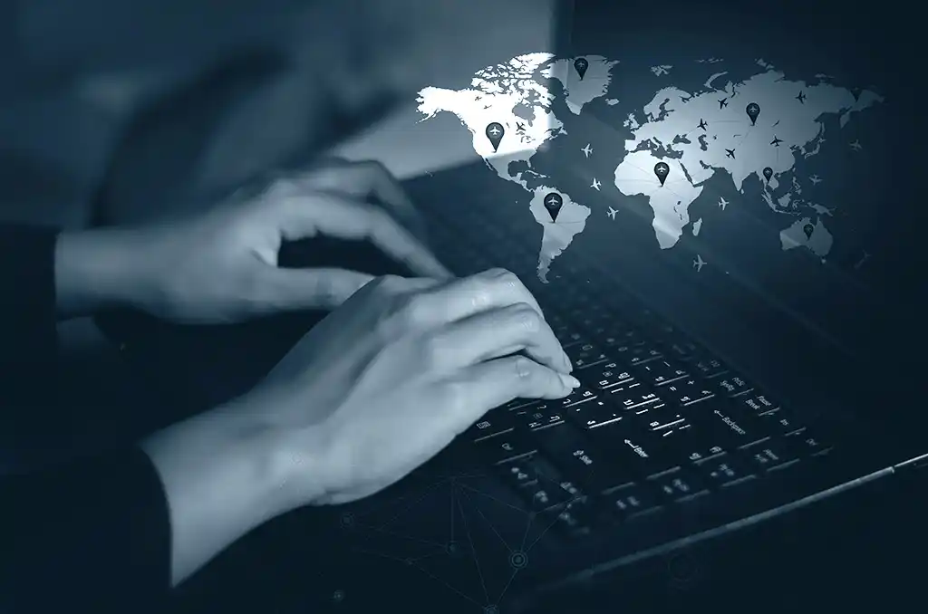 Close up of female hands typing on laptop; Word map with planes and location points superimposed on top